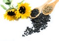 Sunflowers, seeds and wooden spoons on a white background Royalty Free Stock Photo