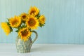 Sunflowers. Summer bouquet in crockery with pastel background Royalty Free Stock Photo