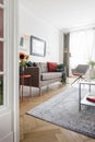 Sunflowers on table in bright flat interior with posters. Real photo