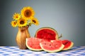 Sunflowers in a vase and sliced watermelon Royalty Free Stock Photo