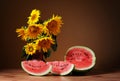 Sunflowers in a vase and watermelon Royalty Free Stock Photo