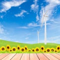 Sunflowers with wind turbine on green grass field against blue s Royalty Free Stock Photo