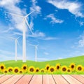 Sunflowers with wind turbine on green grass field against blue s Royalty Free Stock Photo