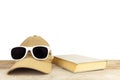 Sunglasses, baseball cap, book, lie on wooden boards on a white background