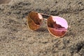Sunglasses at the beach with sea reflection