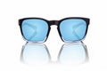 Sunglasses with blue tinted lenses and black frames on white background Royalty Free Stock Photo