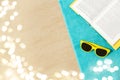 Sunglasses and book on beach towel on sand Royalty Free Stock Photo