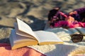 Sunglasses and book on a towel at the beach Royalty Free Stock Photo