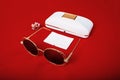 Sunglasses with brown lenses on a red background