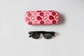 Sunglasses, case with strawberry print on a white background, flat lay, copy space