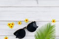 Sunglasses decorate with fern leaves and yellow paper flowers