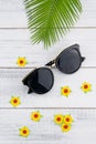 Sunglasses decorate with fern leaves and yellow paper flowers