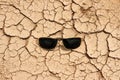 sunglasses on dry crack earth texture