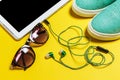 Sunglasses, earphones, blue shoes and a smartphone Royalty Free Stock Photo