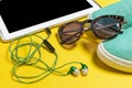 Sunglasses, earphones, blue sneakers and a smartphone Royalty Free Stock Photo