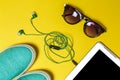 Sunglasses, earphones, shoes and a phone Royalty Free Stock Photo