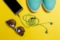 Sunglasses, earphones, shoes and a smartphone Royalty Free Stock Photo