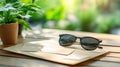 Sunglasses on Envelope with Plant and Bokeh Background Royalty Free Stock Photo