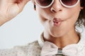 Sunglasses, fashion and face of woman with kiss pose on white background for summer, casual and trendy style. Creative