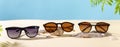 Sunglasses fashion offer banner. Summer sunglass sale-out offer. Sunglasses on a beach sand with tropical leaves. Summer Optics Royalty Free Stock Photo