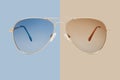 Sunglasses golden metallic frame and blue polarized lenses isolated on beige background