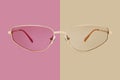 Sunglasses golden metallic frame and polarized lenses isolated on beige and pink background Royalty Free Stock Photo