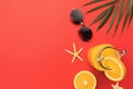 Sunglasses, hat and orange juice on a red background with copy space Royalty Free Stock Photo