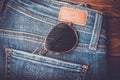 Sunglasses on jean pants retro vintage style Royalty Free Stock Photo