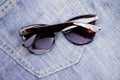 Sunglasses on jeans Royalty Free Stock Photo