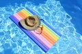 Sunglasses, lilo and hat on the water in hot sunny day. Summer background for traveling and vacation. Holiday idyllic. Royalty Free Stock Photo