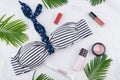 Sunglasses and lip gloss decorate with tiny sailboat, anchor