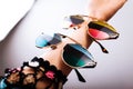 Fashionable sunglasses with multicolored lenses on hand