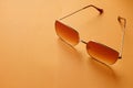 Flat lay  Square sunglasses isolate on a orange background Royalty Free Stock Photo