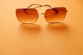 Top view  Square sunglasses isolate on a orange background Royalty Free Stock Photo