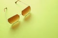 Top view  Square sunglasses isolate on a green background Royalty Free Stock Photo