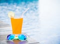 Sunglasses with orange juice and a piece of lemon Royalty Free Stock Photo