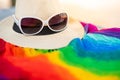 Sunglasses and Panama hat on rainbow scarf