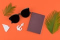 Sunglasses and passport decorate with fern leaves and tiny sailboat and anchor