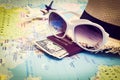 Sunglasses, Passport, Money, Hat and aircraft on the world map Royalty Free Stock Photo