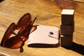 Sunglasses and pink leather wallet on wooden table. Vacatiom summer concept Royalty Free Stock Photo