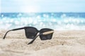 Sunglasses placed on the sandy baeach Royalty Free Stock Photo