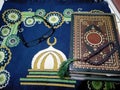 The sunglasses beside the Quran occurring in the mats prayer