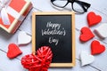 Sunglasses,red and white heart wooden handcraft,box and chalkboard written with Happy Valentine`s day. Royalty Free Stock Photo