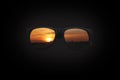 Sunglasses reflecting sunset