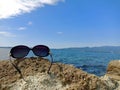Sunglasses on the rock under blue sky in Sado island, Japan Royalty Free Stock Photo