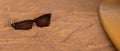 Sunglasses on the sand, summer desert is reflected in the glasses