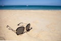 Sunglasses with on the sand on a Sunny summer beach.