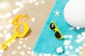 Sunglasses, sand toys and ball on beach towel Royalty Free Stock Photo