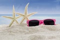 Sunglasses and sea stars at beach Royalty Free Stock Photo