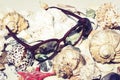 Sunglasses, seashells, sea stars, coral and stones on the sand, summer beach background travel concept with copy space for text Royalty Free Stock Photo